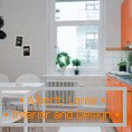 Biela kuchyňa s oranžovým nábytkom